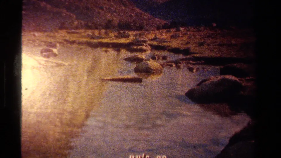 Final Lake Tahoe frame shows the pan moving past sunlit water and rocks, with the title text partly near the bottom edge.