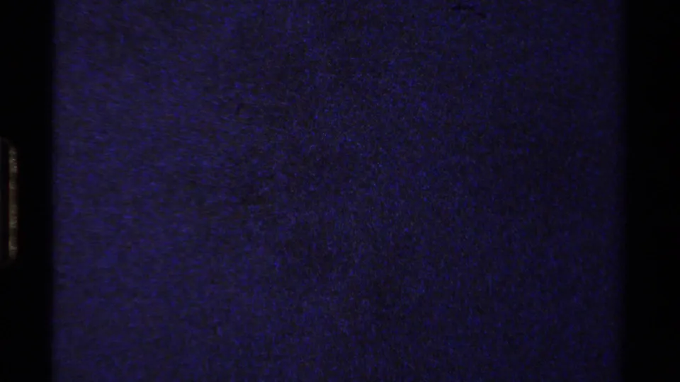 End frame from the 1978 8mm Lake Tahoe clip, mostly blue-purple film exposure with no clear people, objects, or landscape detail visible.