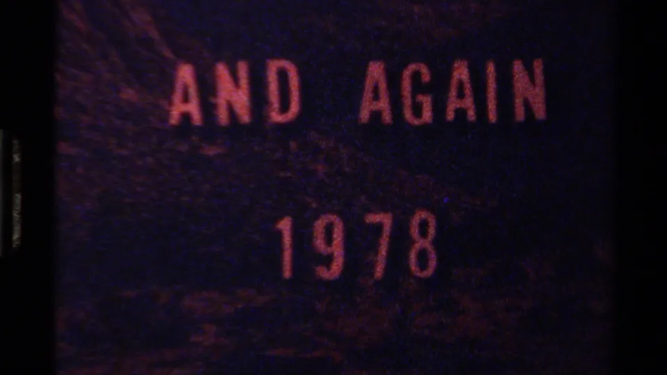 Home-movie title card reading AND AGAIN 1978, rendered in reddish lettering over a dark, grainy frame.