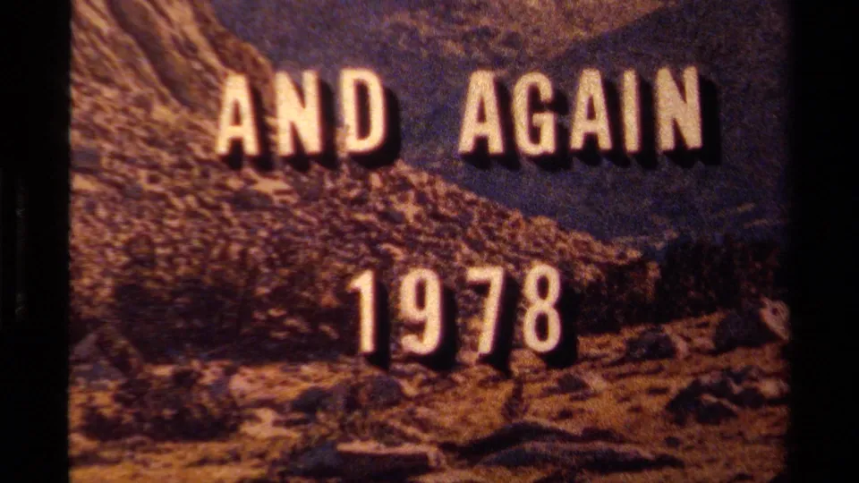 1978 8mm title card reading AND AGAIN 1978 over a rugged Lake Tahoe mountain landscape with dark film borders.