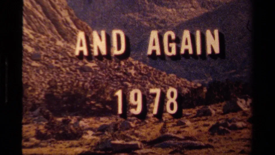Soft, warm 8mm frame showing the AND AGAIN 1978 title over a rugged Lake Tahoe mountain scene.