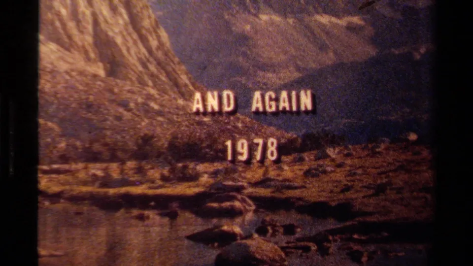 Final 1978 Lake Tahoe title-card frame showing rugged terrain, river foreground, and dark Super 8 frame edges.