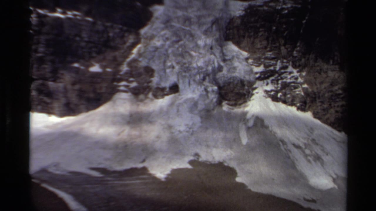 1979 British Columbia 8mm frame showing a glacier and snowfield flowing down a rugged rocky slope.