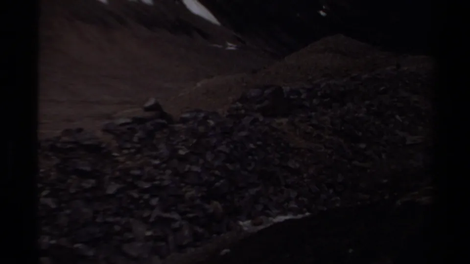 1979 British Columbia 8mm frame showing a wider rocky mountain slope after the marmot close-up.