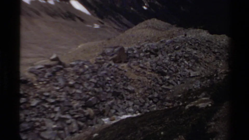 1979 British Columbia 8mm frame of rugged gravel and loose stones on a mountain slope.