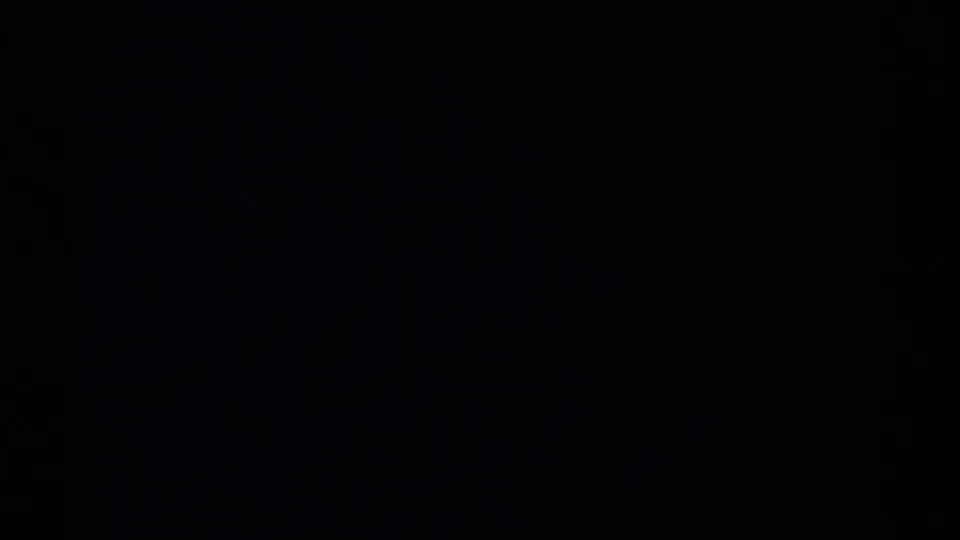 Final 8mm frame cuts to near black, suggesting the end of the shot or reel after the mountain scenery.