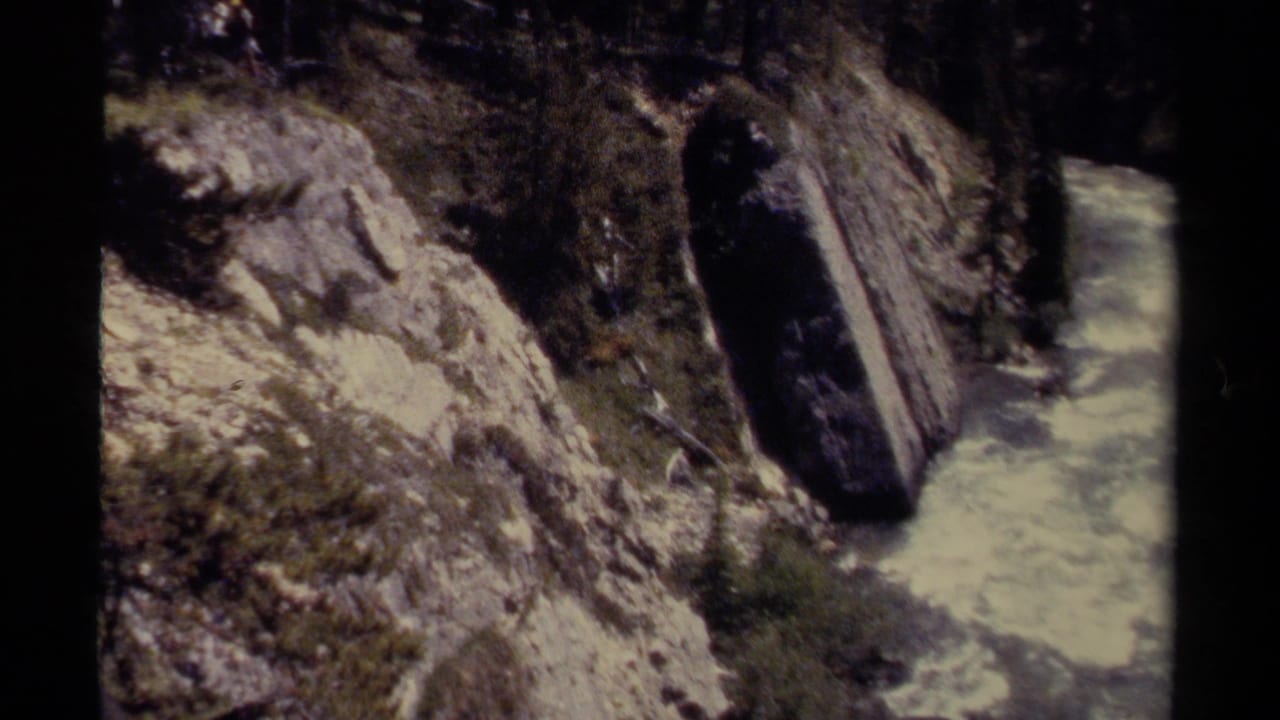 Rushing river in a rocky canyon viewed from above.