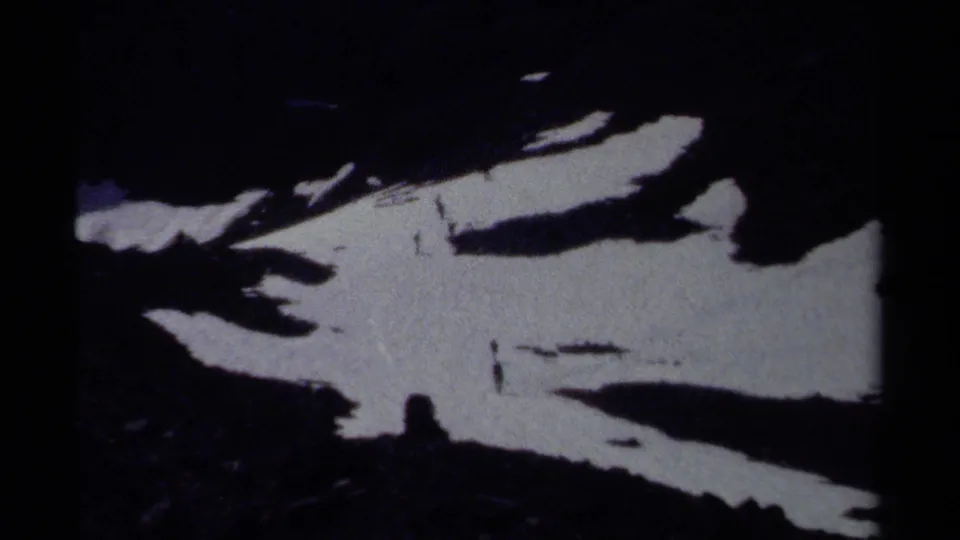 1979 British Columbia 8mm close view of irregular snow patches lying across dark exposed rock.