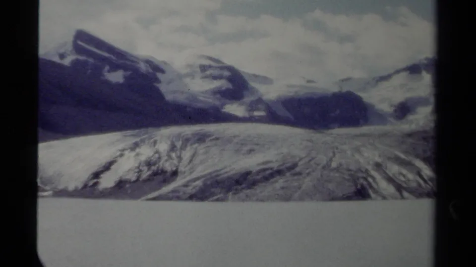1979 8mm home-movie view of snow-capped mountains and a broad glacier in British Columbia, Canada.