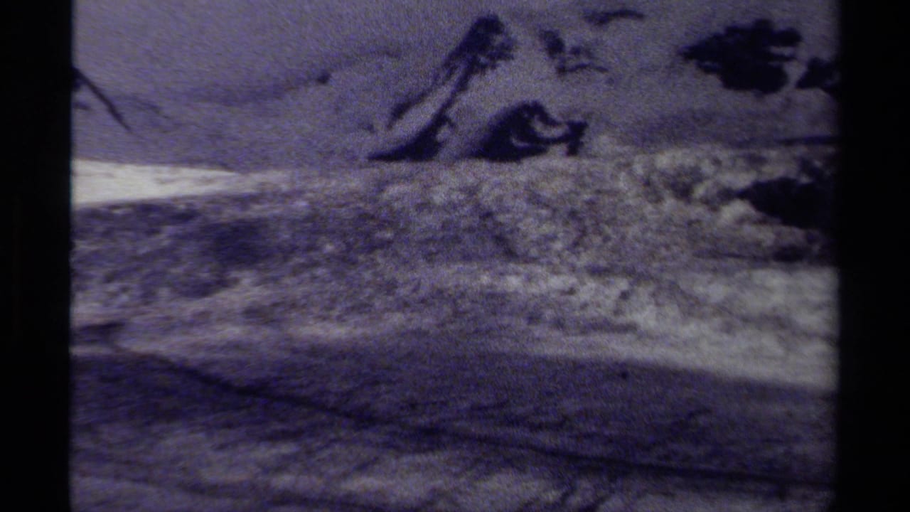 1979 British Columbia 8mm footage showing a faded, soft-focus view across snow and exposed rock in an alpine landscape.