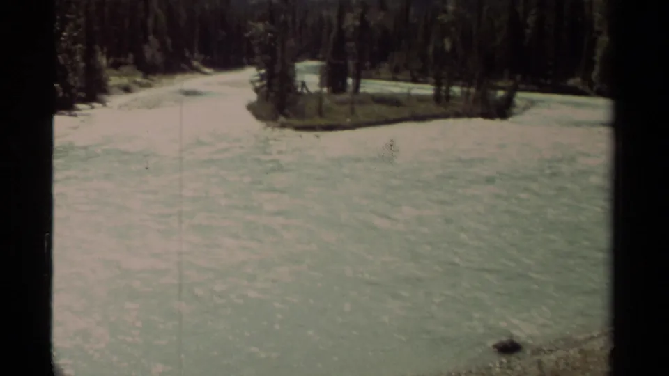 1979 British Columbia 8mm footage appears to show a rippling river beside dense evergreen forest in a mountain setting.