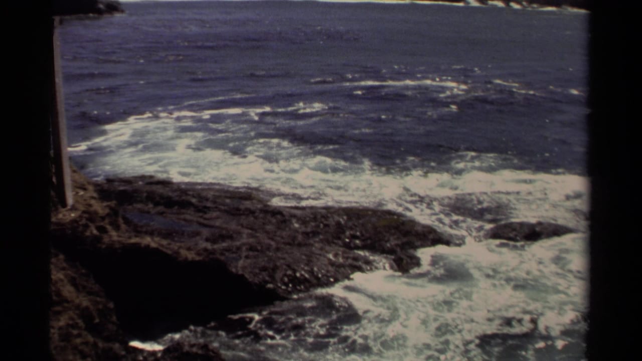 Mendocino shoreline footage from 1980 shows foamy waves moving across dark coastal rocks.