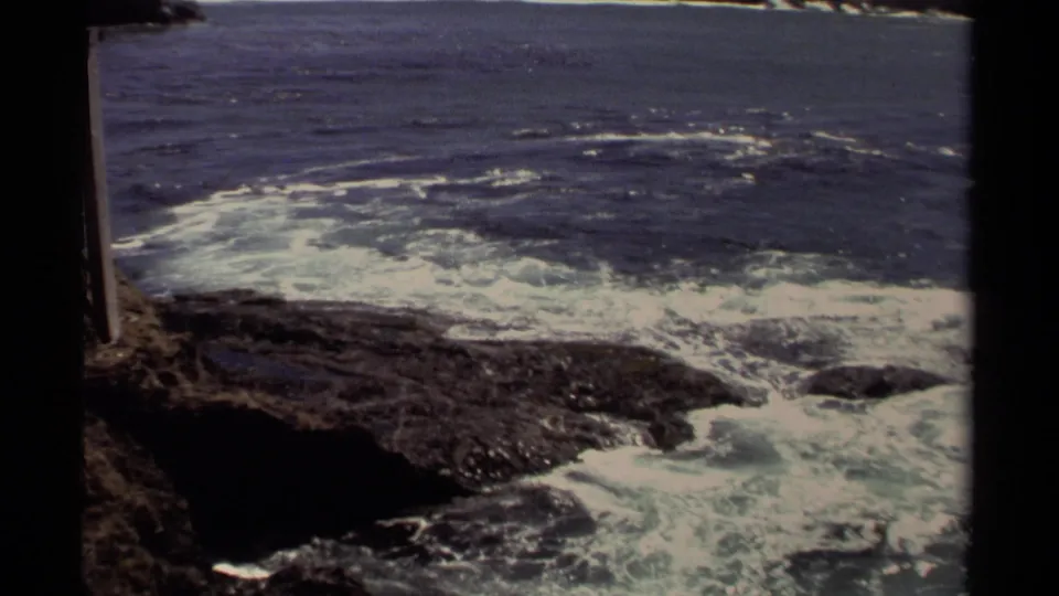 Mendocino shoreline footage from 1980 shows foamy waves moving across dark coastal rocks.