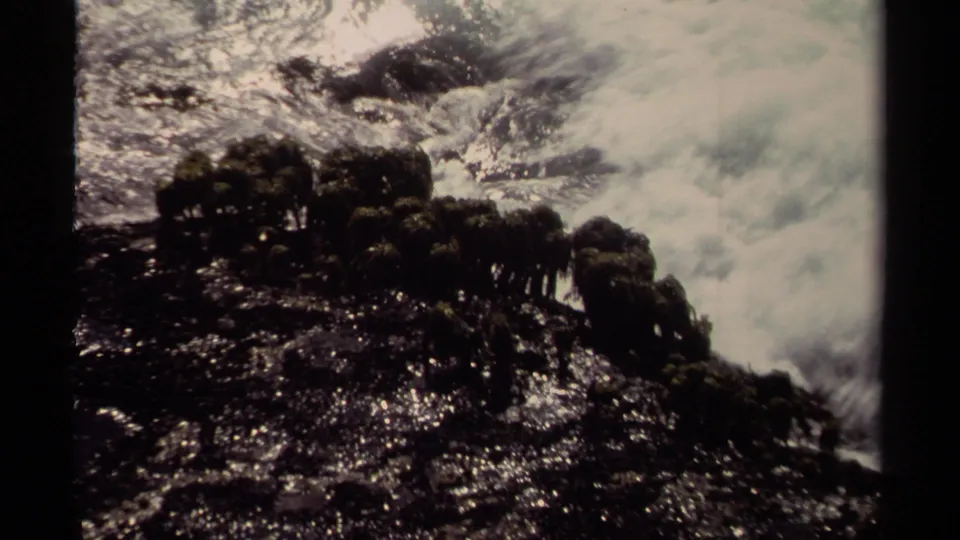 Wet jagged rocks and rushing surf appear in a high-contrast 8mm view of the Mendocino shoreline.