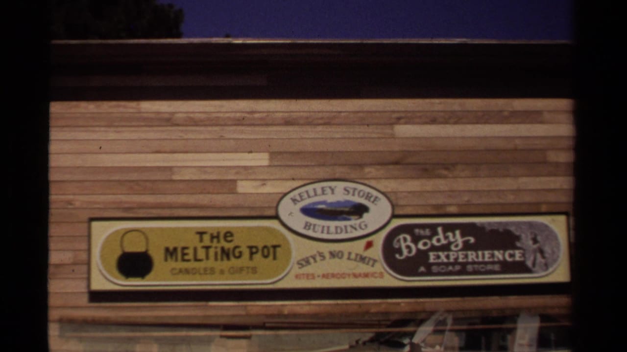 1980 Mendocino storefront signage on a wood-sided building, including The Melting Pot and The Body Experience.