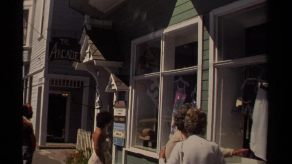 1980 Mendocino street view with pedestrians near The Arcade sign, green storefront trim, and window displays.