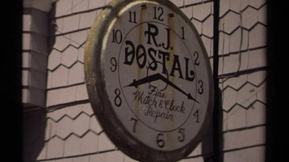 In Mendocino, California, a weathered R.J. Dostal Fine Watch & Clock Repair sign hangs on a shingled storefront in 1980 footage.