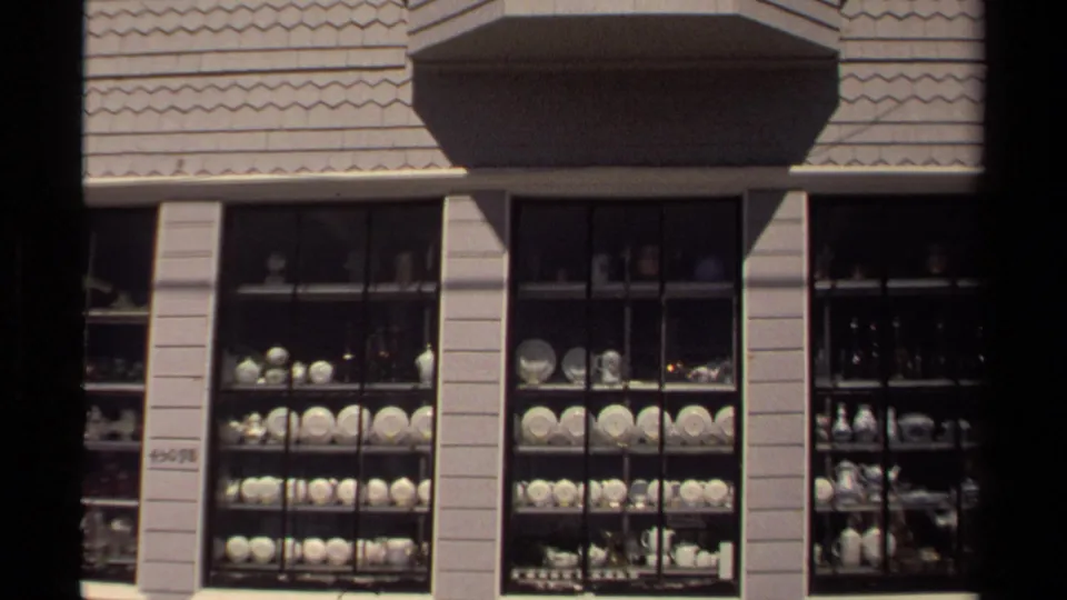 Wider Mendocino storefront view showing the bay window, multi-pane shop windows, and china or glassware arranged in rows inside.