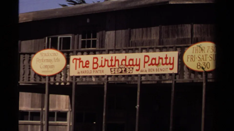 Mendocino Art Center facade with a banner for Harold Pinter's The Birthday Party, visible on 1980 8mm footage.