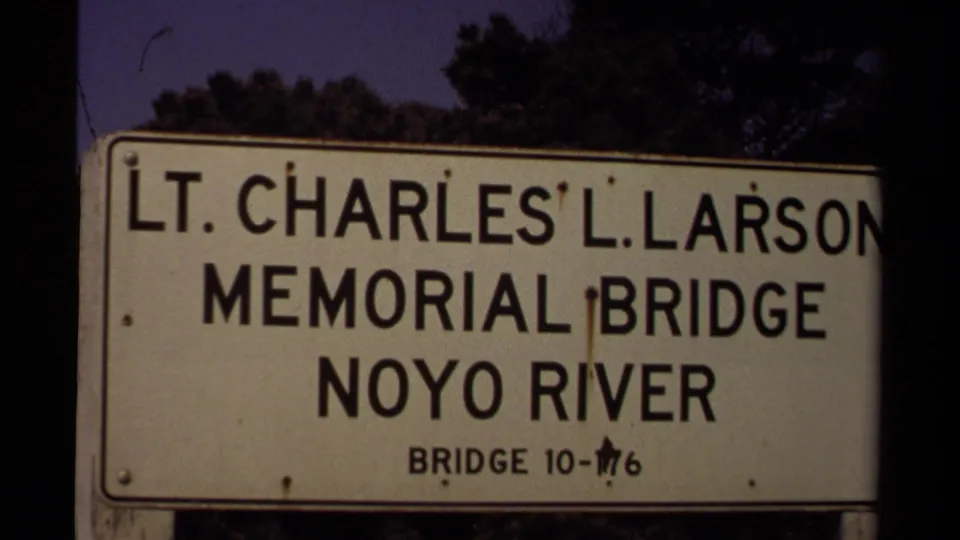 Centered 8mm close-up of the Lt. Charles L. Larson Memorial Bridge sign identifying the Noyo River location in Mendocino, California.