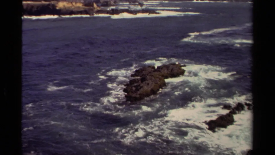 A rocky outcrop sits amid churning Pacific surf in this 1980 Mendocino 8mm coastal view.