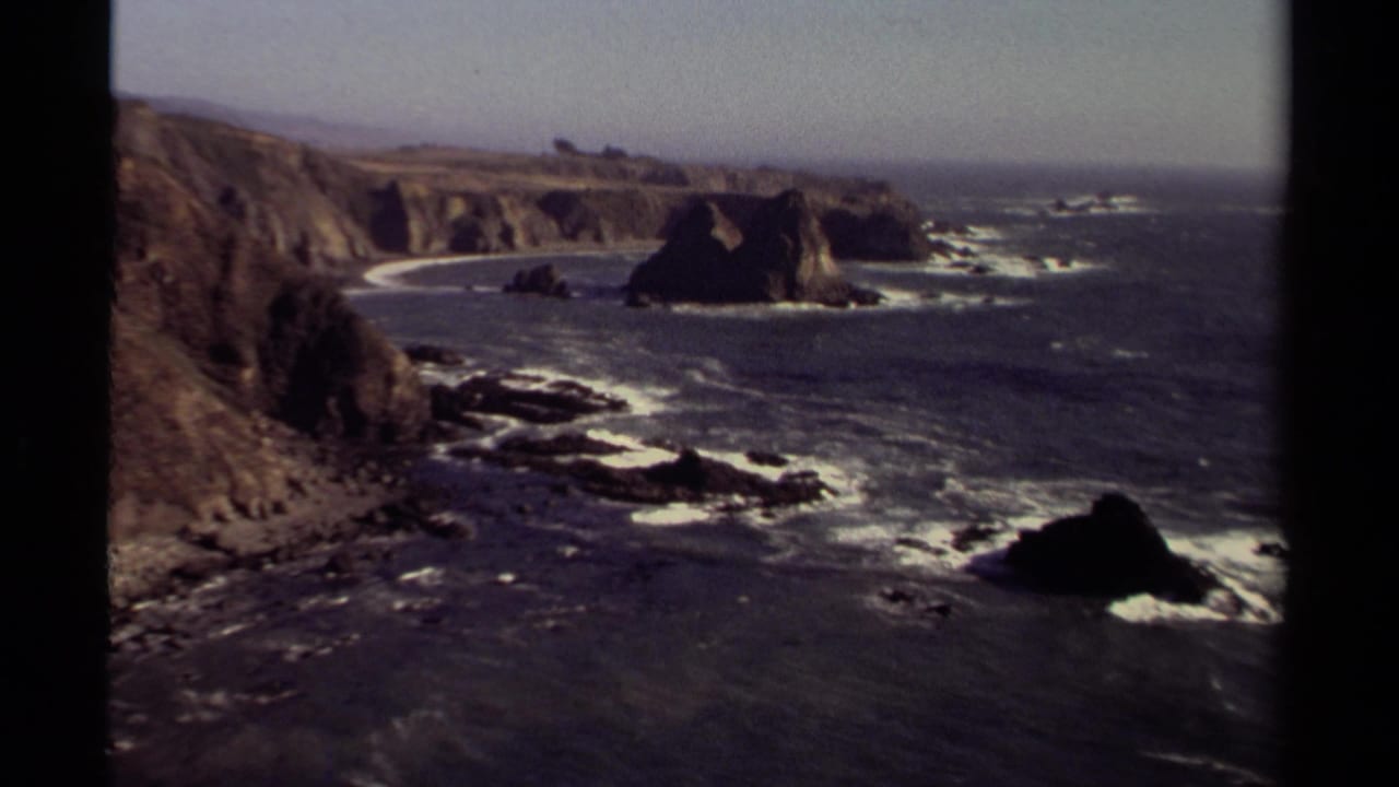 Rocky Mendocino coastline with cliffs, offshore rocks, surf, and ocean horizon.