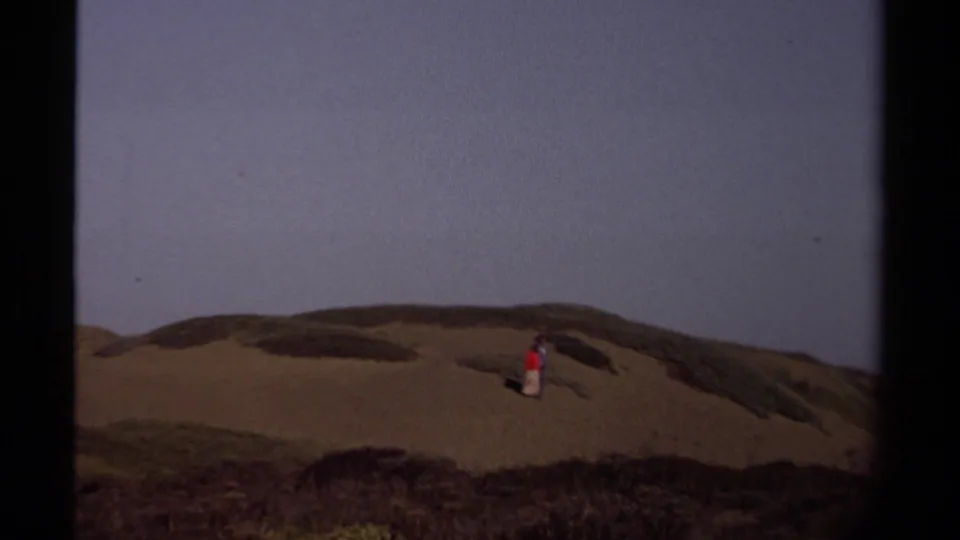 The final frame shows a closer 1980 home-movie view of a person in red on Mendocino dunes with sky above.