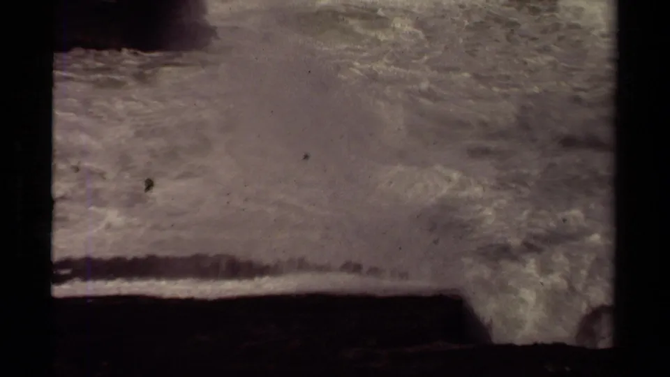 Foam and spray fill the frame as surf surges along the rocky Mendocino shoreline in 1980 8mm footage.