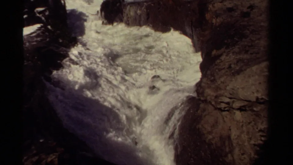 Mendocino 1980 8mm frame showing foaming Pacific surf surging through a narrow rocky channel.