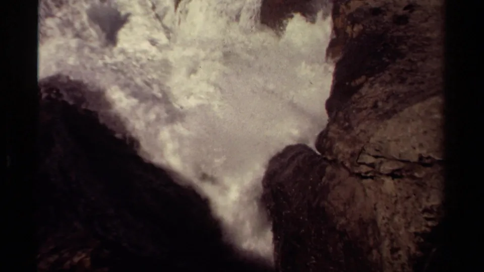 Mendocino 1980 8mm frame showing turbulent white water filling a rocky channel along the coast.