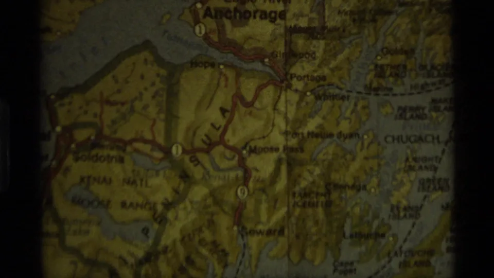 Close-up of an Alaska map showing Anchorage, Portage, Seward, and Kenai Peninsula routes in a 1977 home movie.