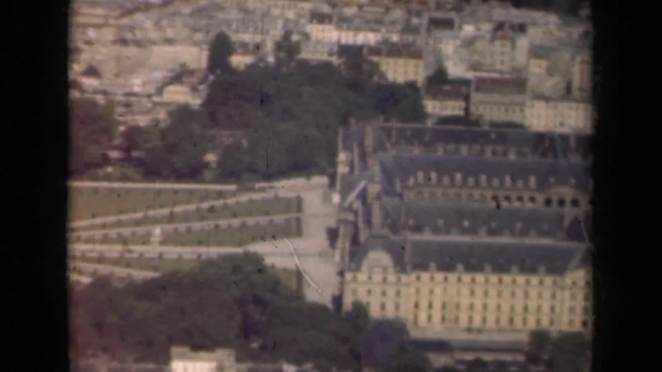 1939 Paris aerial view showing the Louvre area and formal garden paths, framed by the edge of an aircraft window.
