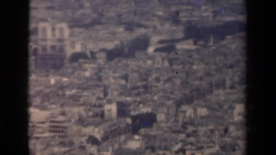1939 Paris aerial view with cathedral-like towers, surrounding rooftops, and dark 8mm contact-sheet frame edges.