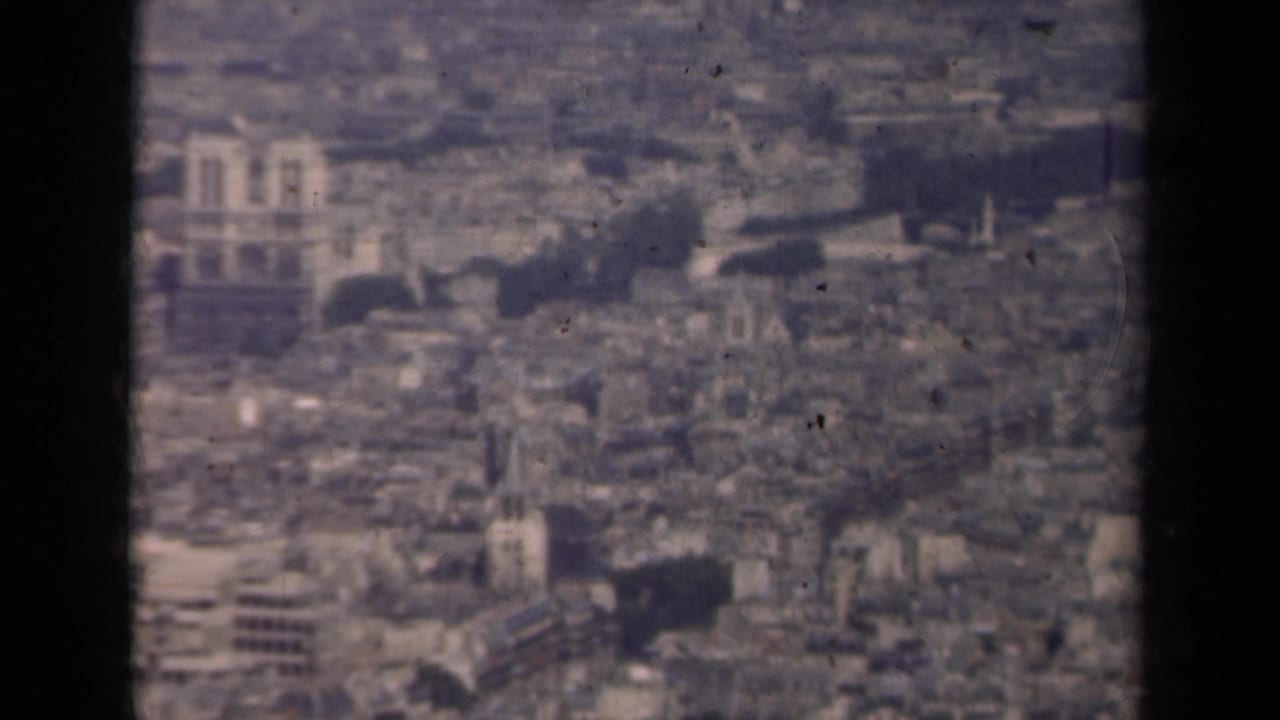Aerial Paris cityscape with Notre-Dame and surrounding historic buildings.