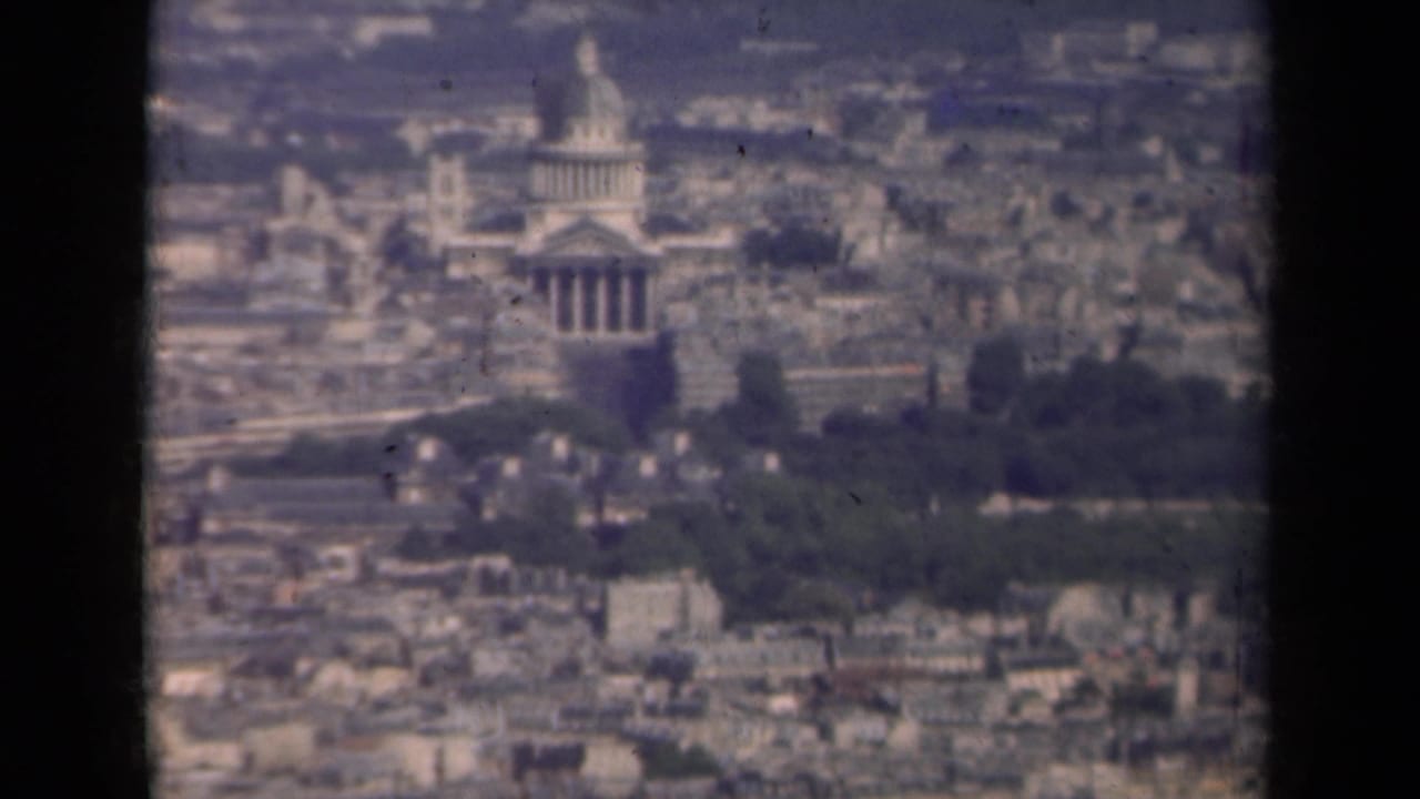 Similar distant view of the Invalides dome and surrounding city.