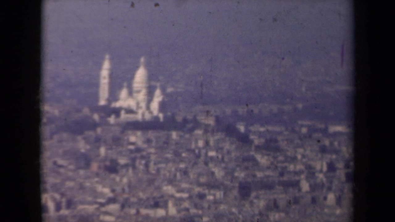 Distant Sacre-Coeur and surrounding city seen through soft haze.