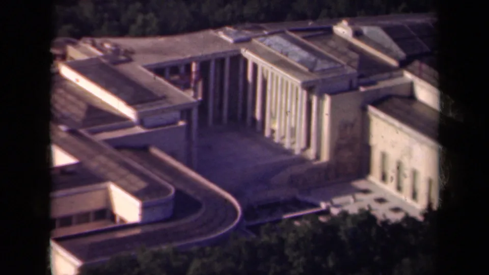 1939 Paris aerial view showing the building's columned wing, rounded facade, multi-level roof, trees, and nearby streets or terraces.
