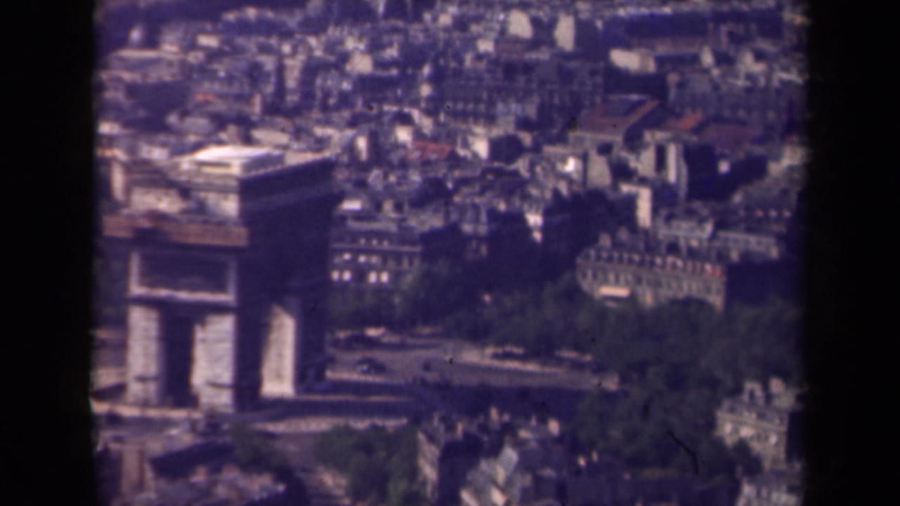 Arc de Triomphe seen from above with surrounding Paris streets and traffic.