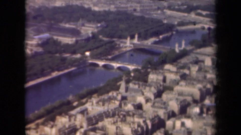 Paris aerial view from 1939 showing the Seine, bridge spans, treed banks, and crowded rooftops within visible 8mm contact-frame borders.