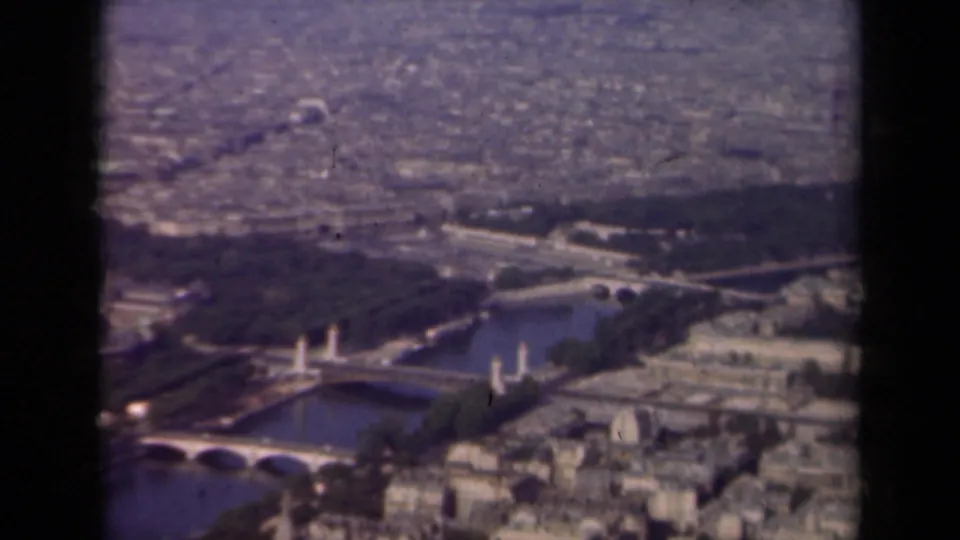 Wide 1939 aerial view across Paris, with the Seine and bridges in the foreground and the city extending into the distance.