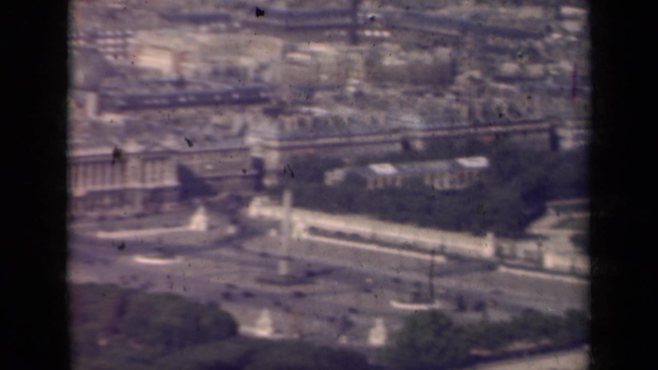 1939 Paris aerial view panning across rooftops, the Seine, formal gardens, bridges, and monumental urban features.