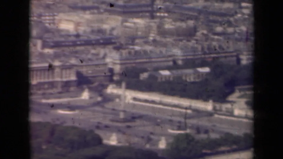 1939 Paris aerial view panning across rooftops, the Seine, formal gardens, bridges, and monumental urban features.