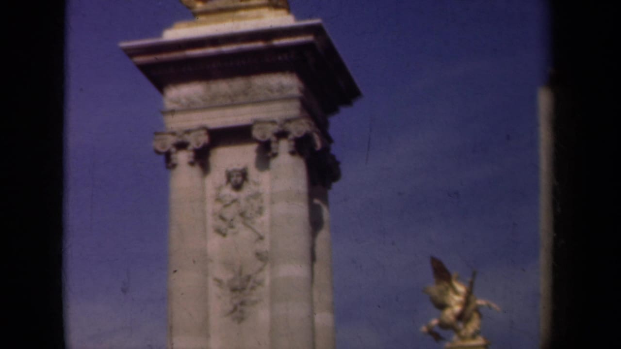 1939 Paris frame of an ornate stone pedestal with relief carving, cornice detail and a gilded winged horse sculpture partly visible to the right.