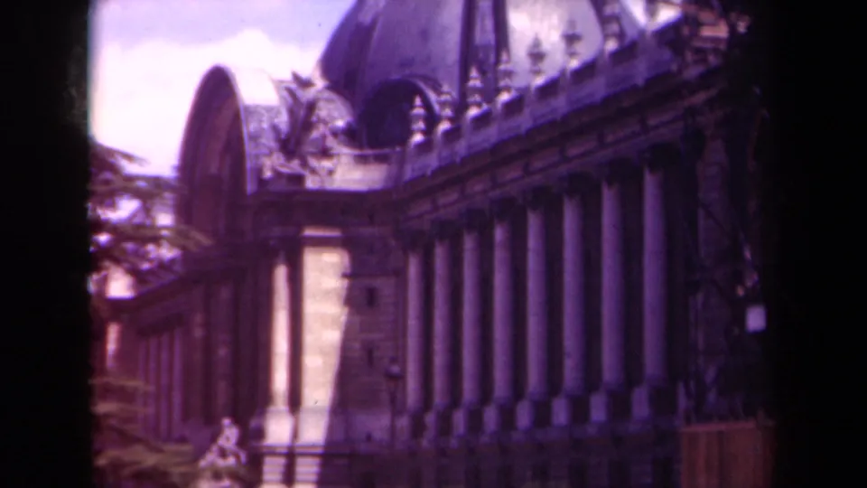 1939 Paris 8mm frame showing a grand stone facade with tall columns, ornate roofline, and a domed structure above.