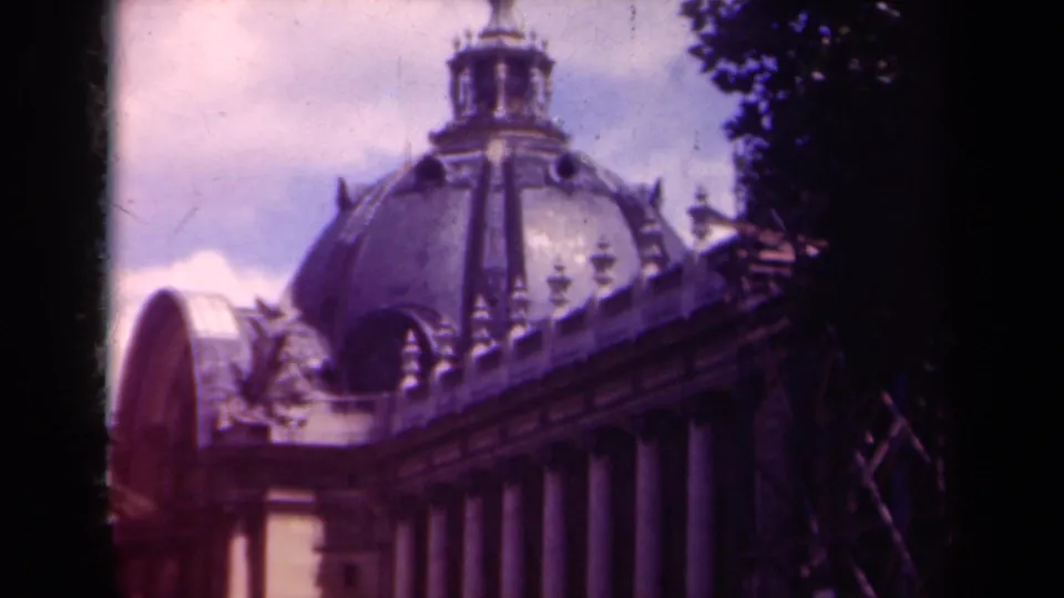 Final 1939 Paris frame showing the building's dome, columned facade, decorative roofline, sky, and dark tree-shadowed border.
