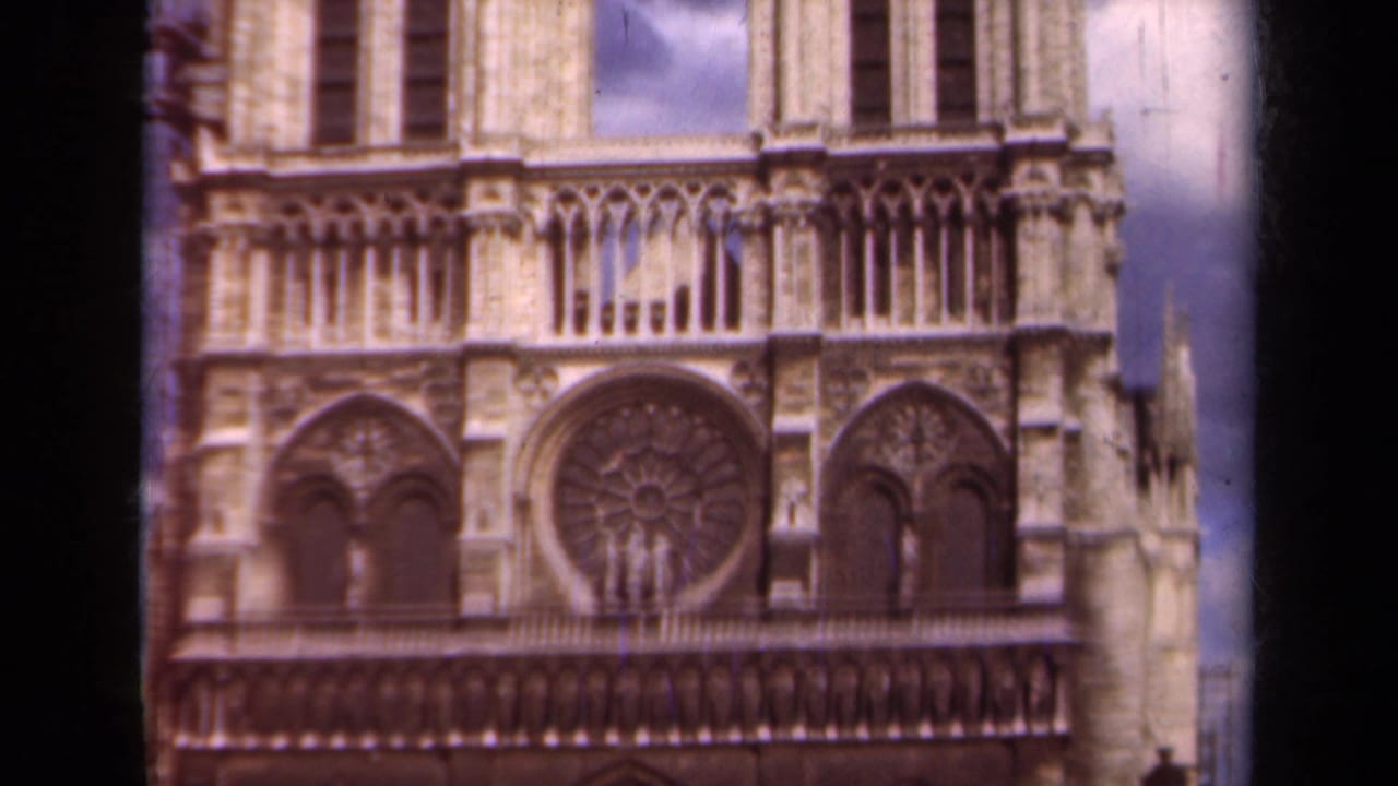 1939 Paris frame of Notre-Dame's west facade with the circular rose window, flanking arches, and upper architectural detail.