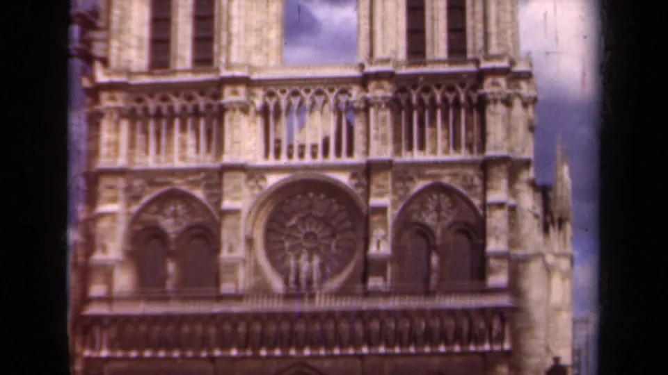 1939 Paris frame of Notre-Dame's west facade with the circular rose window, flanking arches, and upper architectural detail.