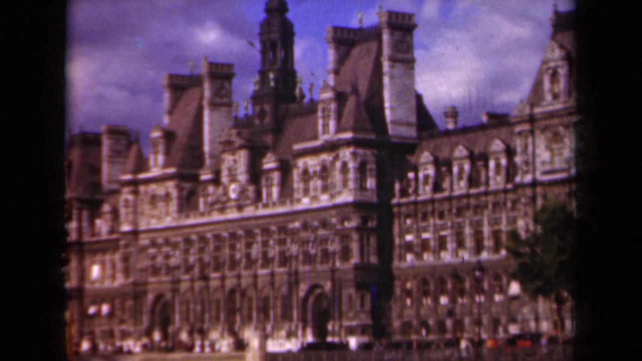 1939 Paris frame of the Hôtel de Ville, with decorative windows, steep roofs, chimneys, cloudy sky, and visible 8mm frame border.