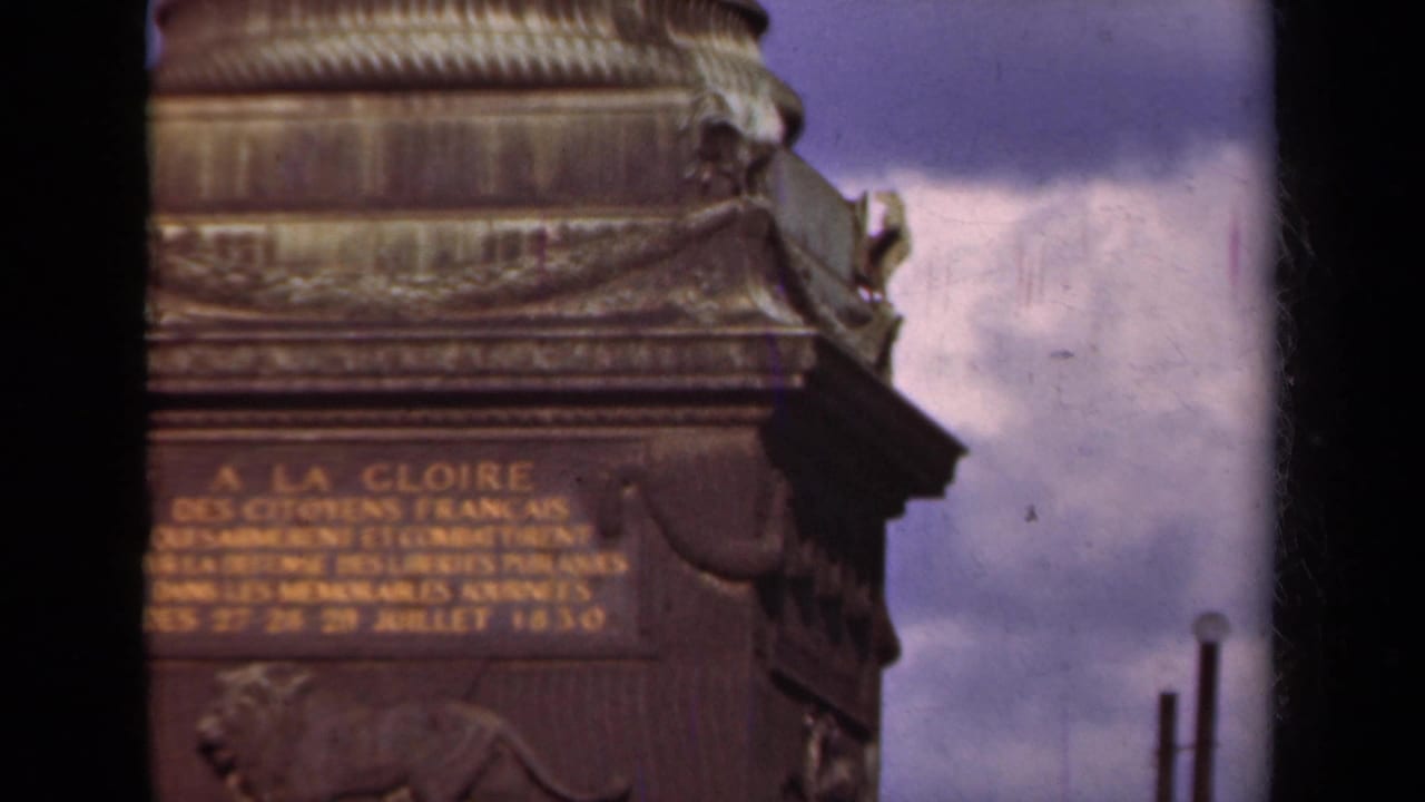1939 Paris 8mm frame showing a soft, handheld close view of the Arc de Triomphe inscription and stone ornamentation.