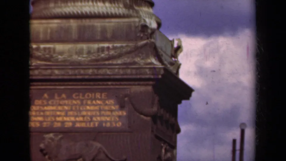 1939 Paris 8mm frame showing a soft, handheld close view of the Arc de Triomphe inscription and stone ornamentation.